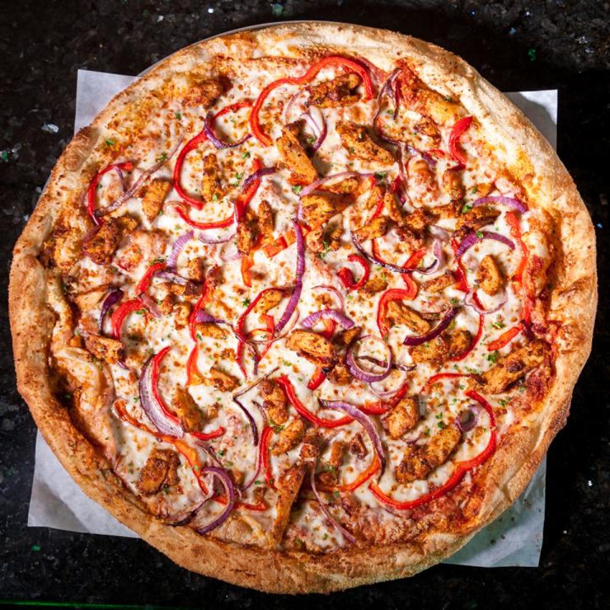 Spicy chicken strips, red onions, roasted red peppers & smoked mozzarella - Schmizza Pub & Grub - Cornell Portland, OR
